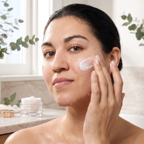 Clinique skincare set on marble bathroom counter in soft natural daylight